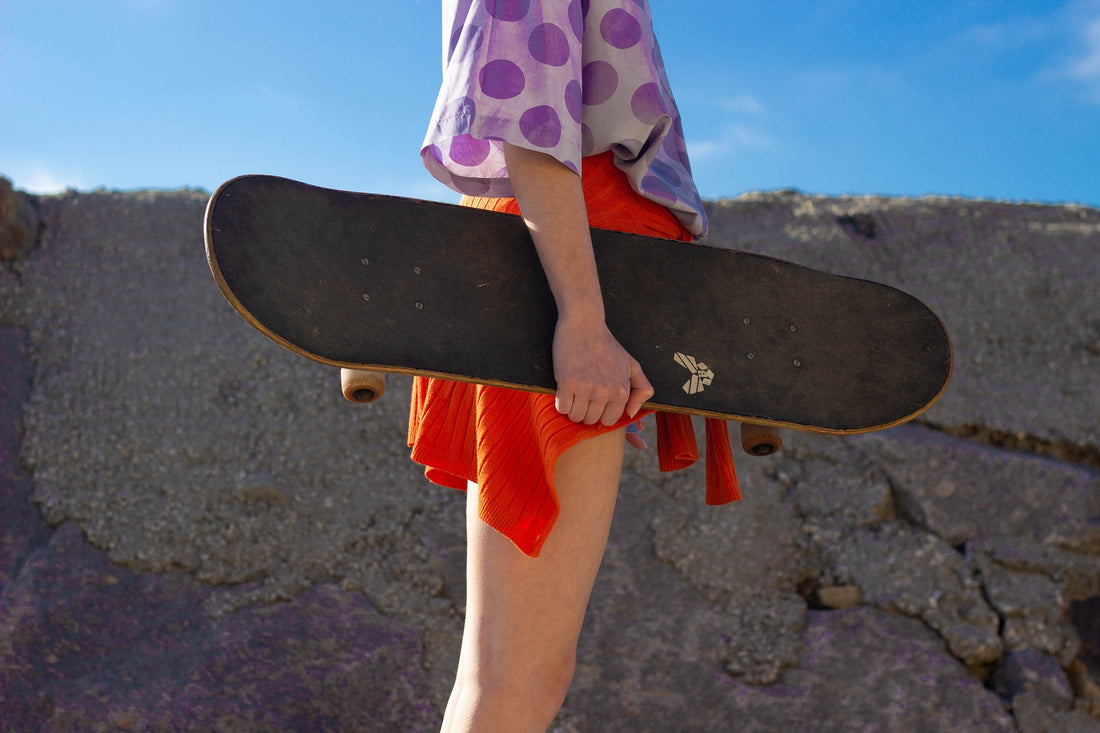 Girl in the 1980s holding skateboard
