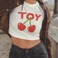White Crop Top with words TOY and cherries.